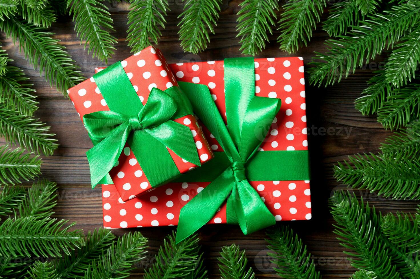 Top view of gifts box decorated with a frame made of fir tree on wooden background. New Year present time concept photo