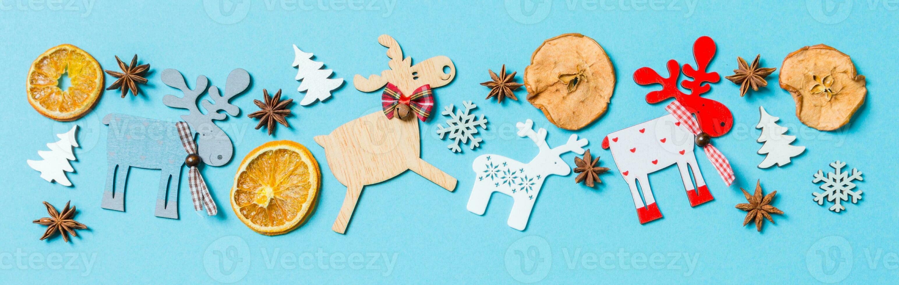 Top view of holiday decorations and toys on blue background. Banner Christmas ornament concept with empty space for your design photo