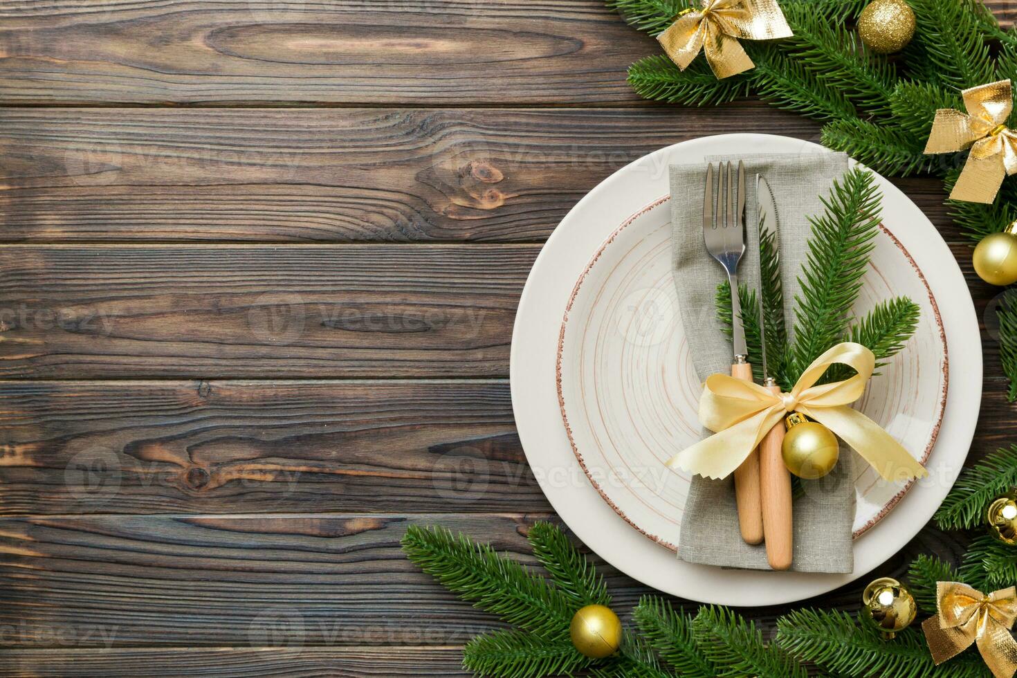 Christmas table place setting with christmas decor and plates, kine, fork and spoon. Christmas holiday background. Top view with copy space photo