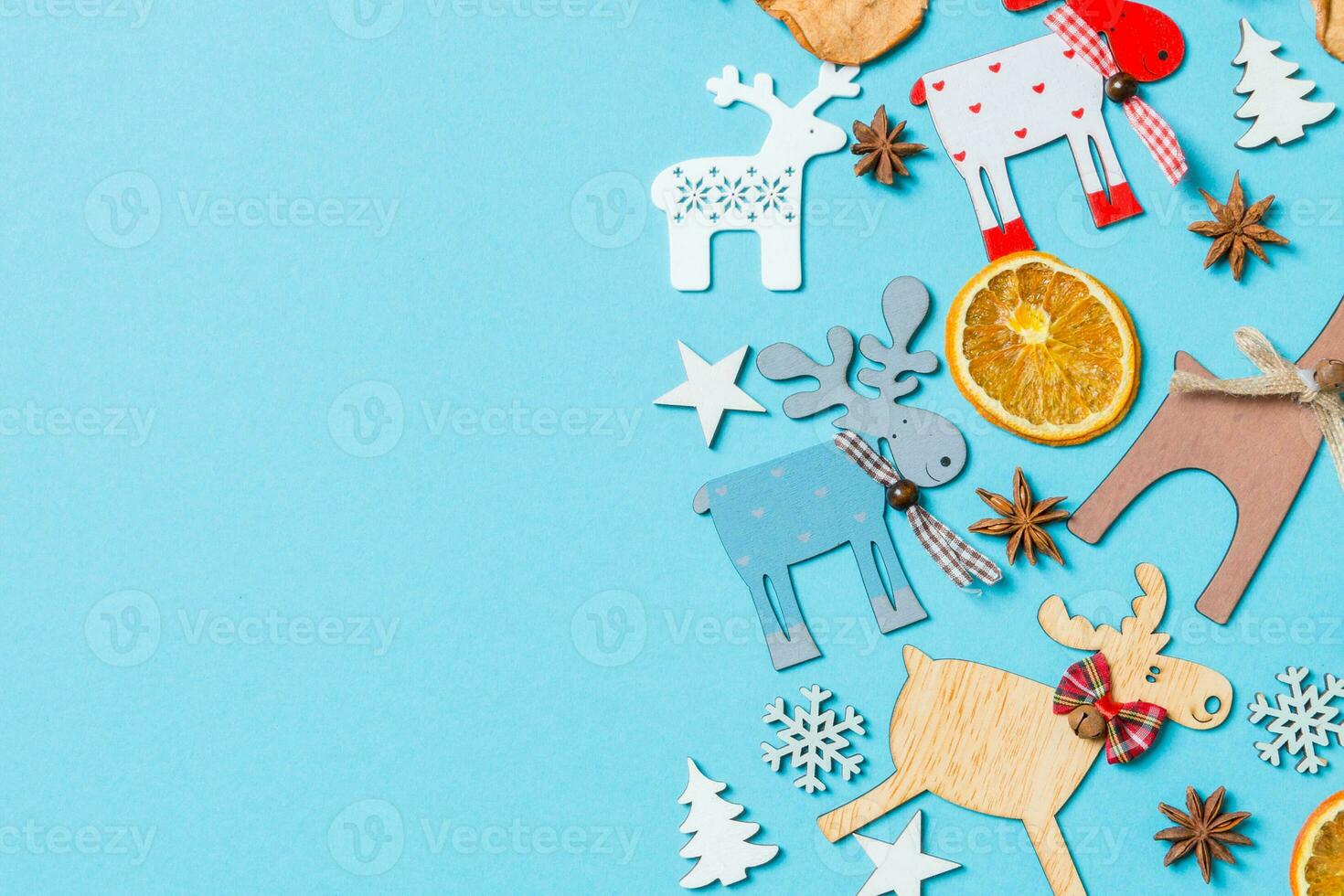 Top view of holiday decorations and toys on blue background. Christmas ornament concept with empty space for your design photo