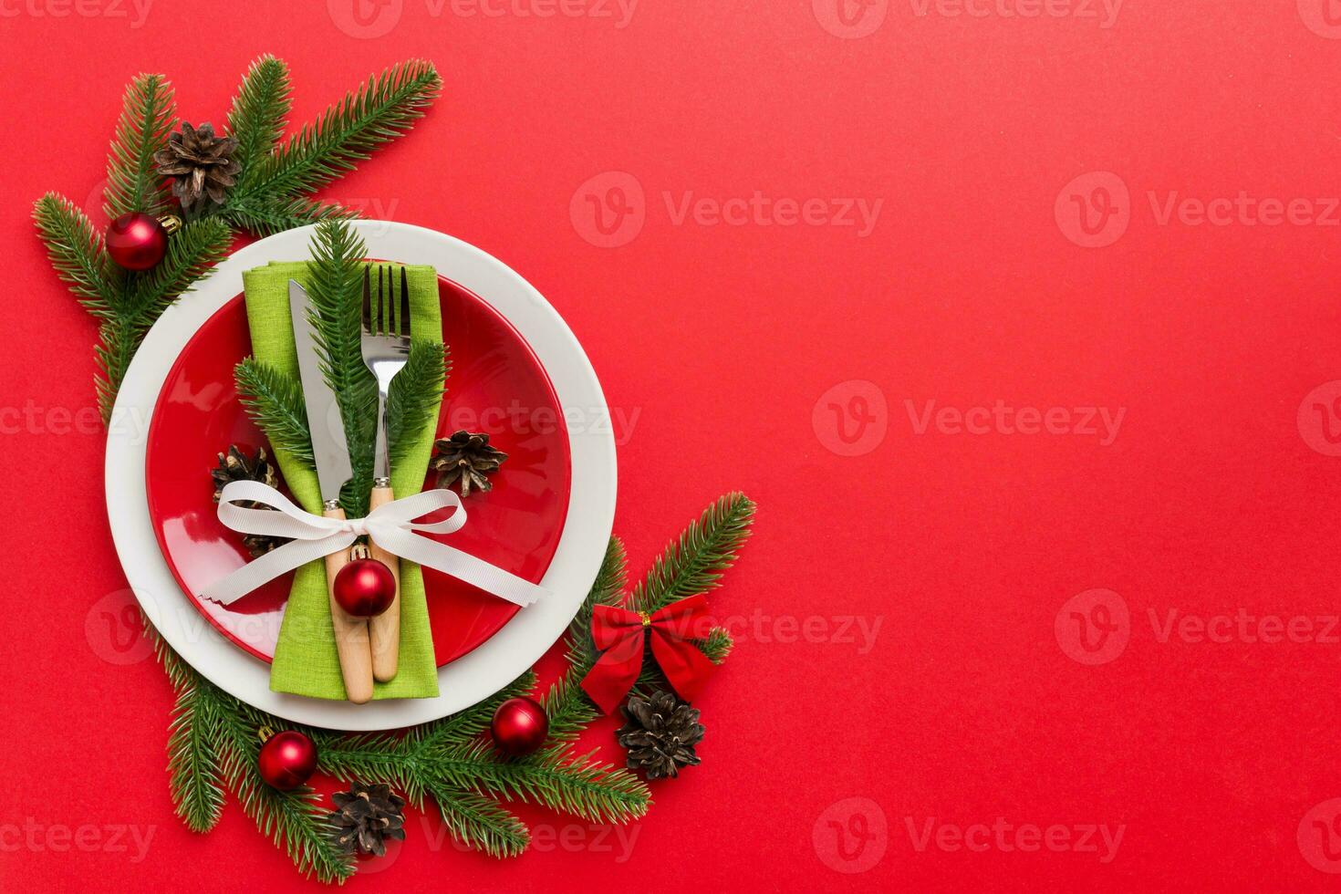 Christmas table place setting with christmas decor and plates, kine, fork and spoon. Christmas holiday background. Top view with copy space photo