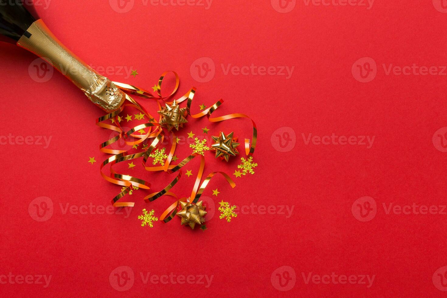 Creative flat lay composition with bottle of champagne and space for text on color background. Champagne bottle with colorful party streamers. holiday or christmas concept photo