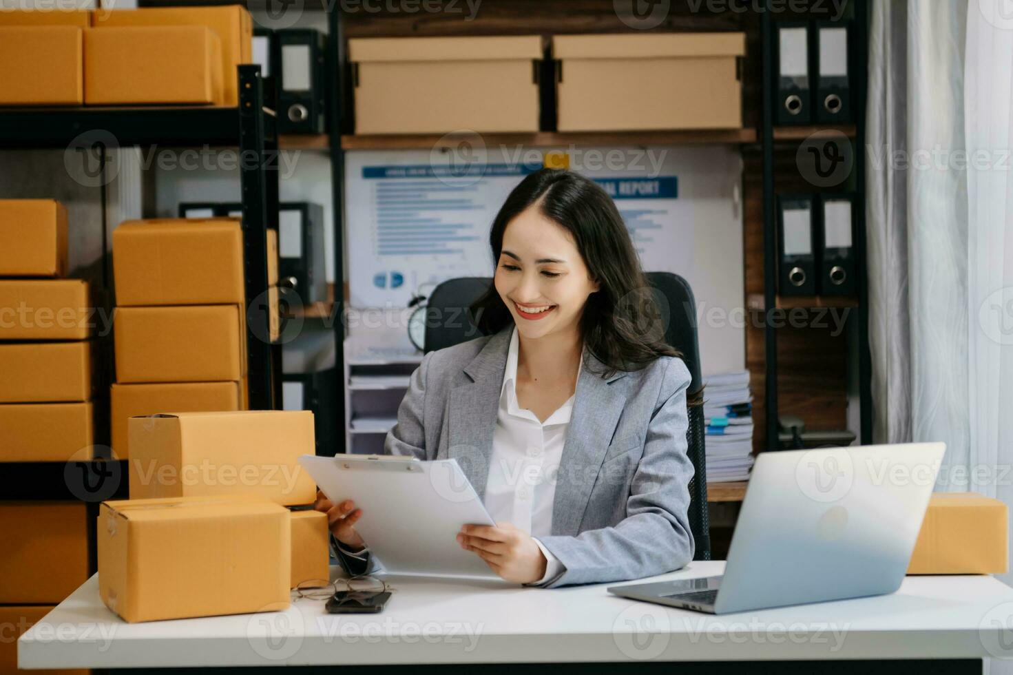 Asian woman SME working with a box the workplace. start up small business owner, small business entrepreneur SME and delivery concept. photo