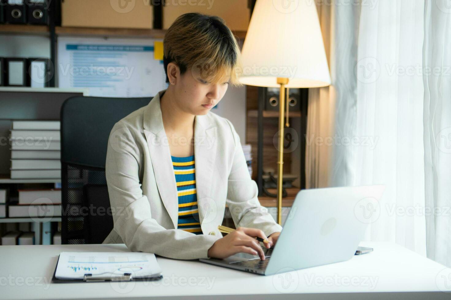 Young Woman Account Manager Working at Table with New Business Project. Typing keyboard,Using Contemporary Laptop. photo