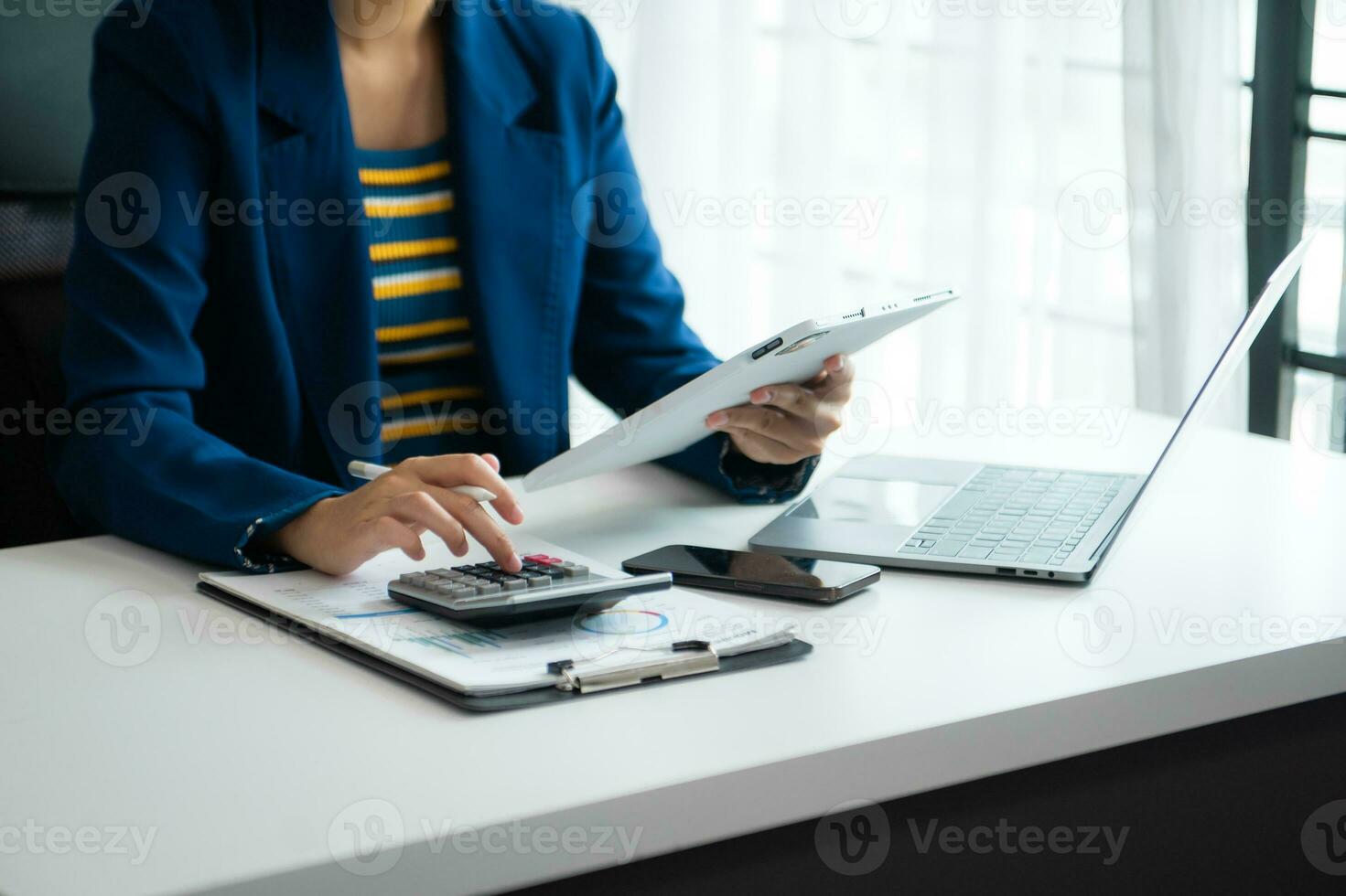 Businessman hands working with finances about cost and calculator and laptop with tablet, smartphone at office photo