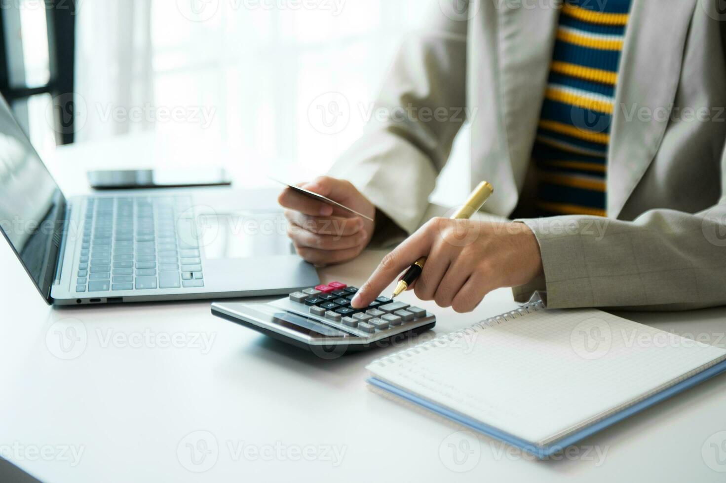 Businessman hands working with finances about cost and calculator and laptop with tablet, smartphone at office photo