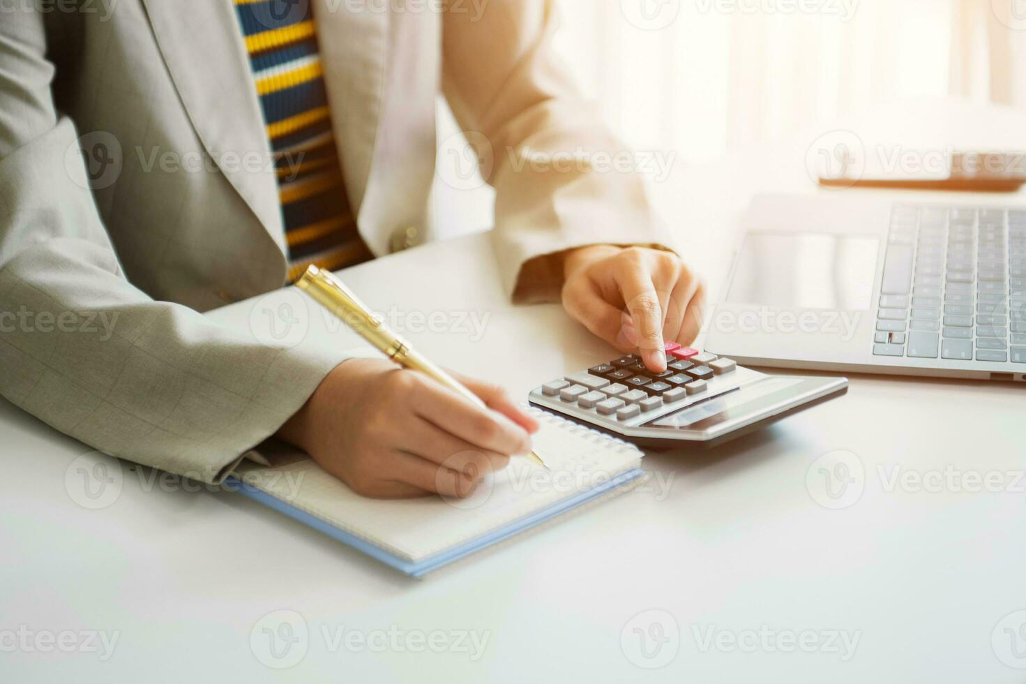 Businessman hands working with finances about cost and calculator and laptop with tablet, smartphone at office photo