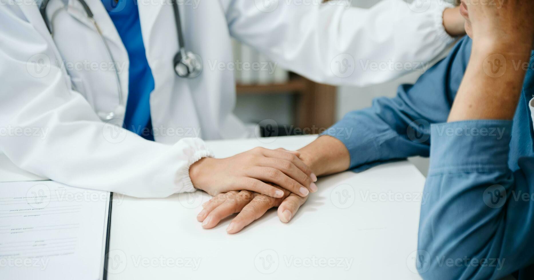 The doctor holds the patient s. hand Healthcare and medical concept. photo