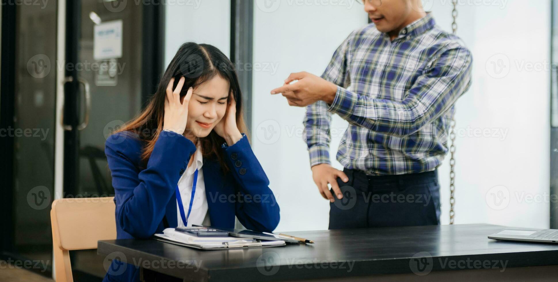 Furious two Asian businesspeople arguing strongly after making a mistake at work in office photo