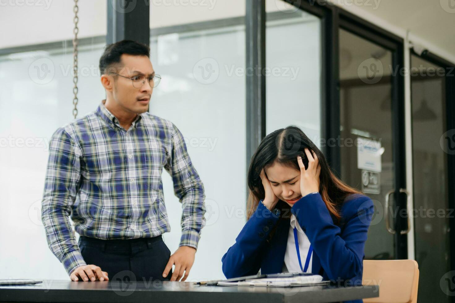 Furious two Asian businesspeople arguing strongly after making a mistake at work in office photo