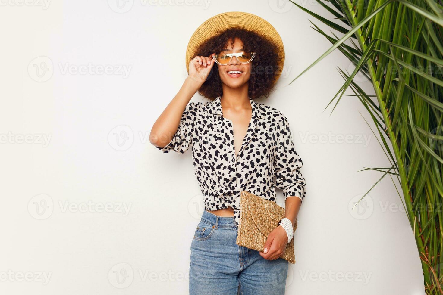 Stylish  black woman  posing with happy face expression on white background. Tropical mood.  Cool sunglasses and accessorizes. photo