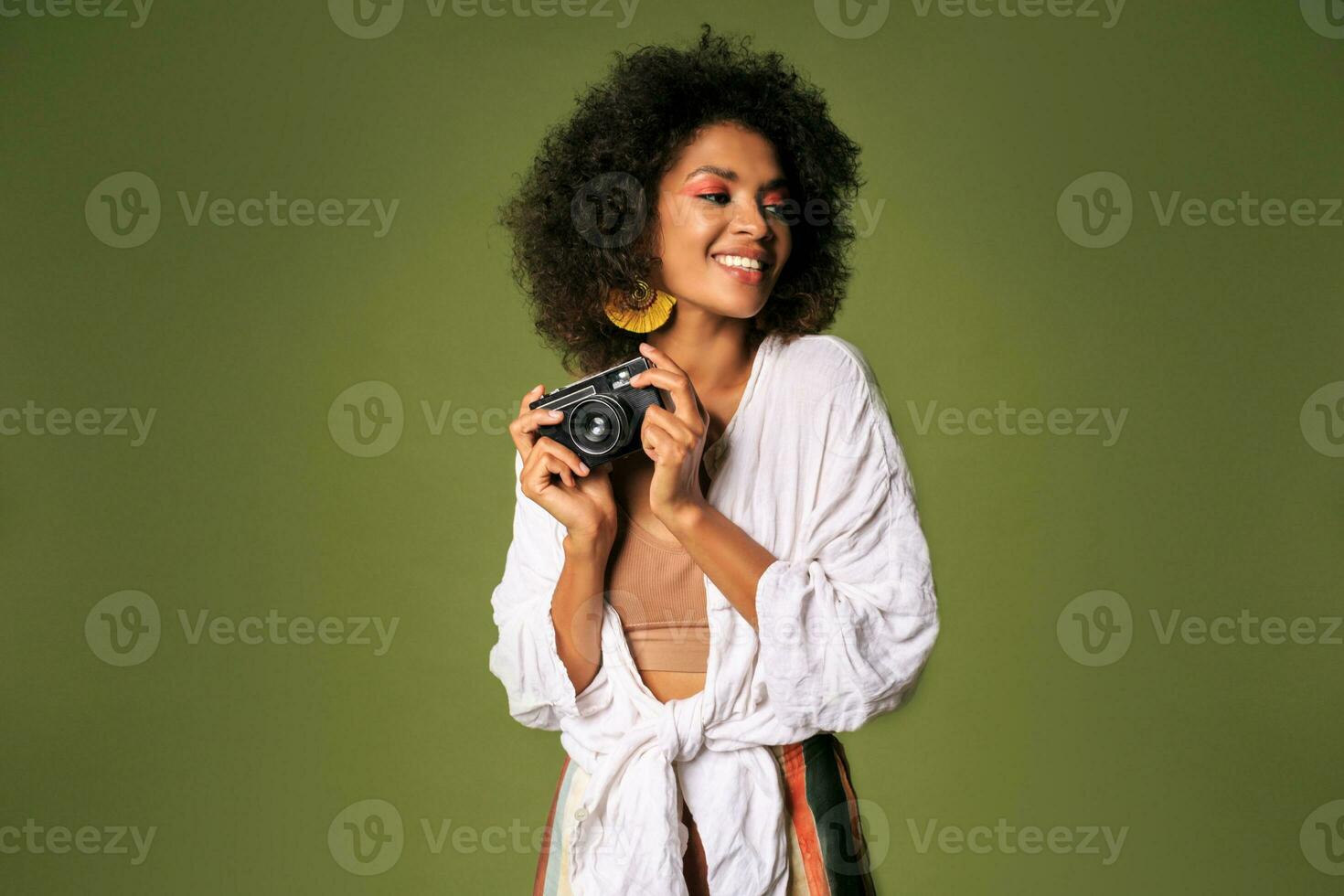 Pretty african woman with stislish hairstyle posing in studio photo