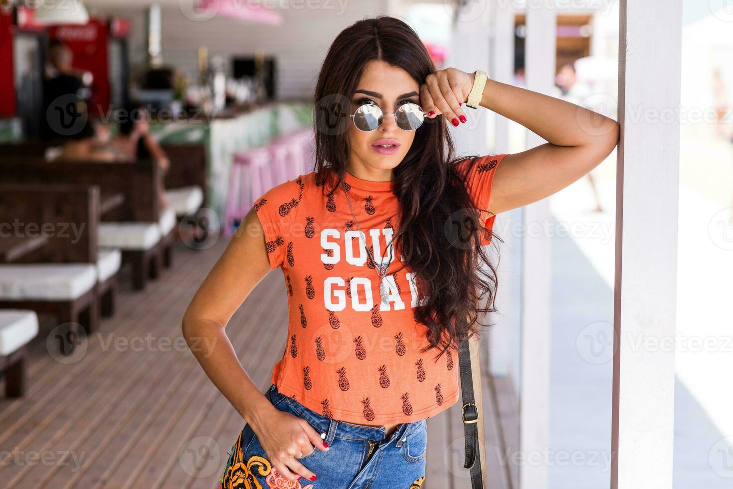 Outdoor   lifestyle  portrait of young amazing brunette woman , orange print t-shirt . photo