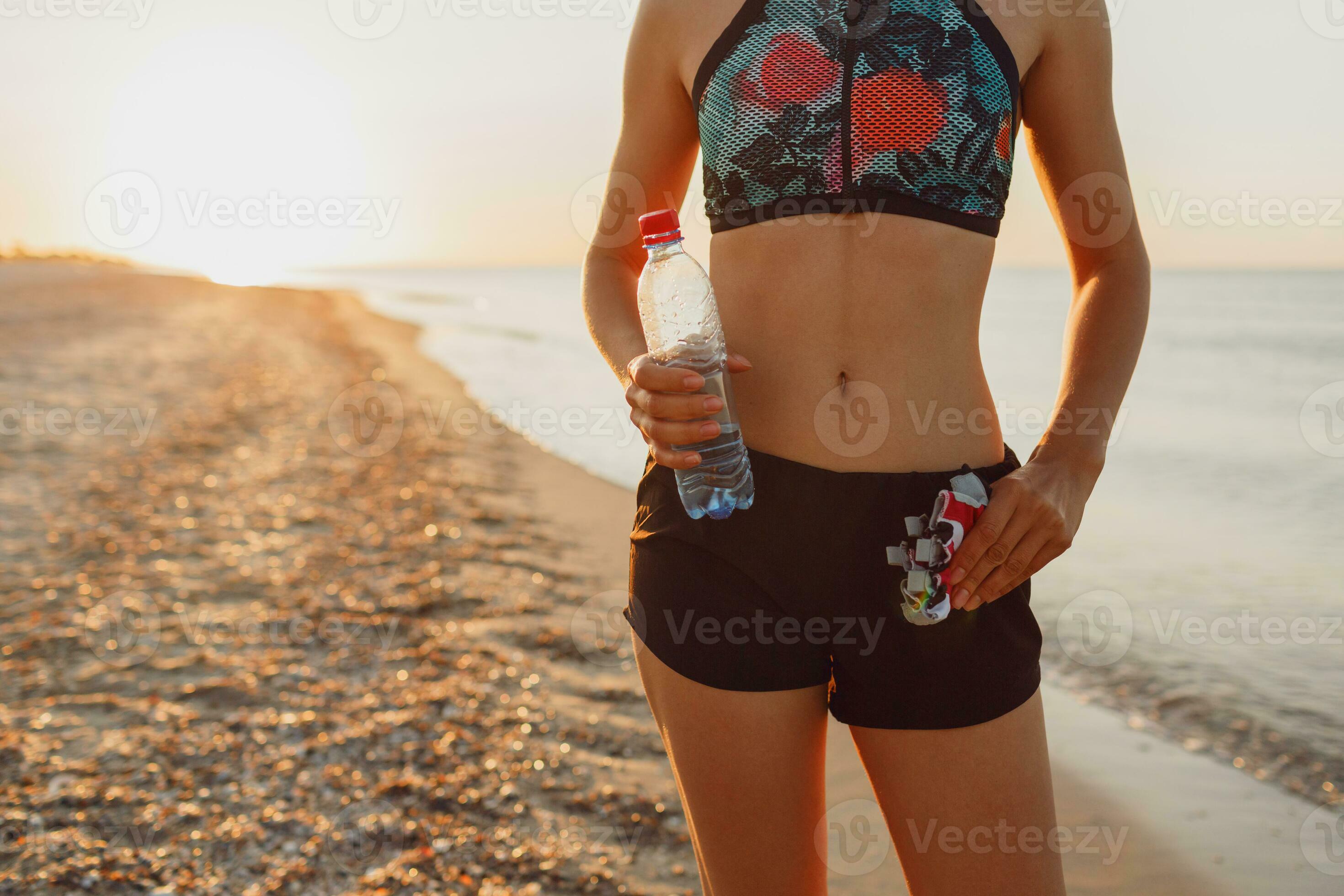 a woman in a sports bra and shorts is doing yoga on the beach 31417238  Stock Photo at Vecteezy