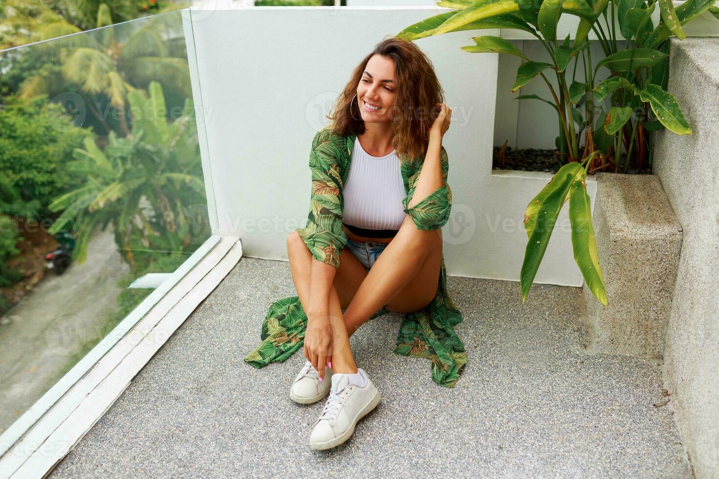 Woman in stylish dress posing outdoor photo