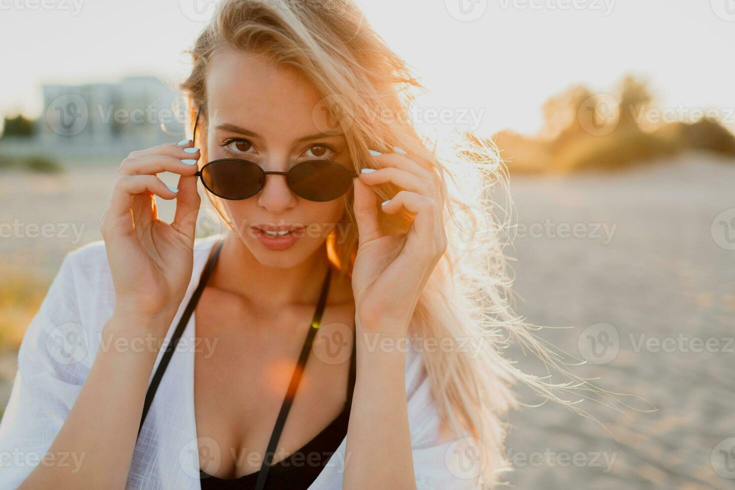 Stylish blonde woman in sunglasses enjoing tropical vacation suring holidays. Perfect skin. photo