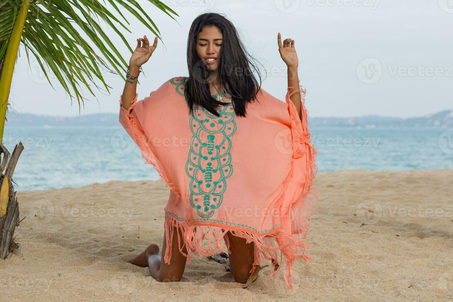 Amazing sexy tan asian woman posing on paradise tropical beach under the pam tree. photo