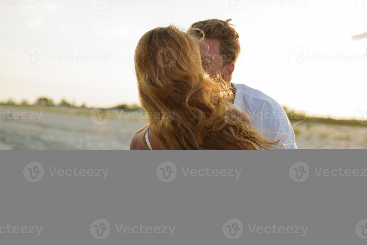 Romantic moments of happy european couple in love enjoing  tropical vacation on the beach.  Hugging and having fun together. photo