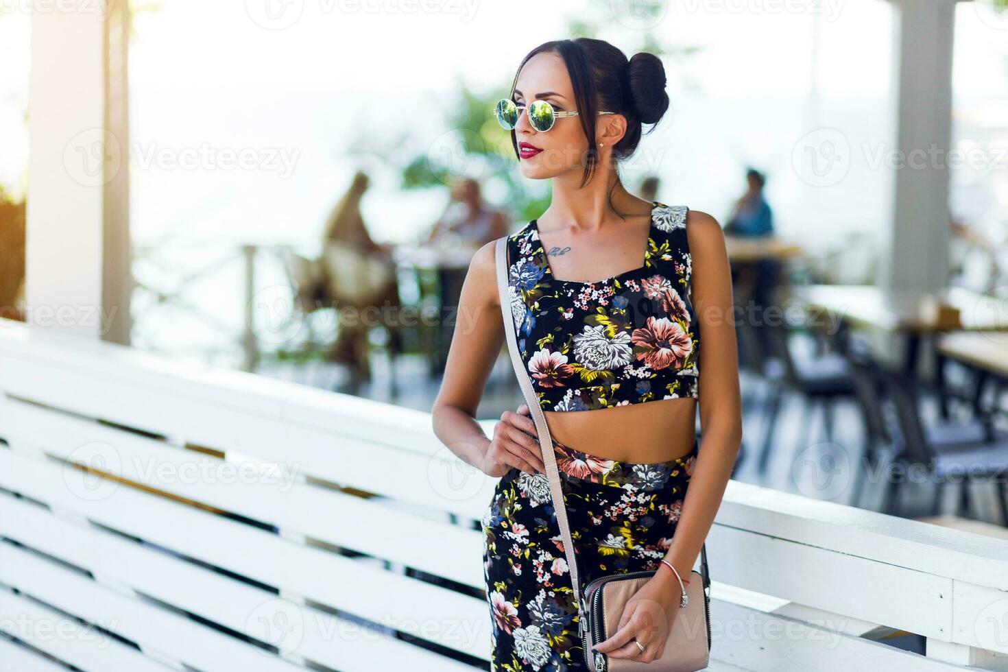 Pretty brunette woman posing  outdoor in sunny summer day. photo
