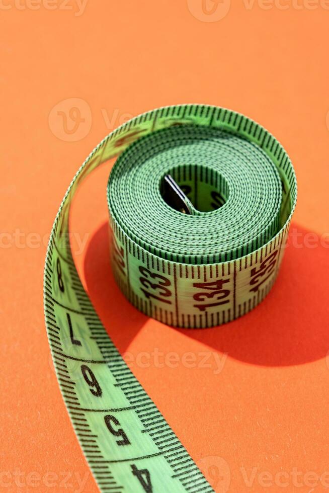 colorful measuring tapes top view on bright red background photo