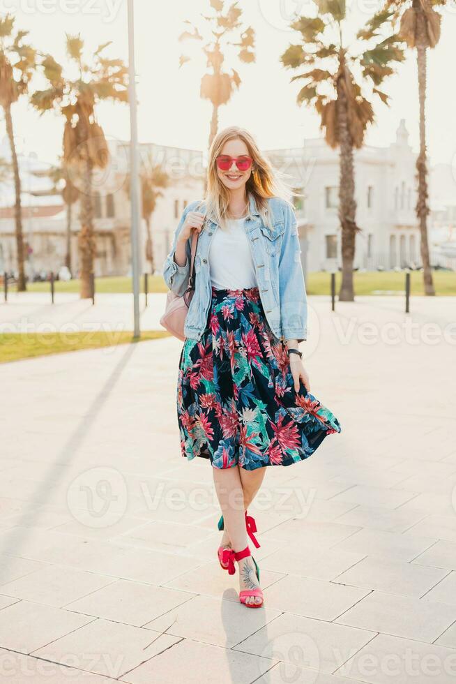 pretty smiling woman walking in city street photo