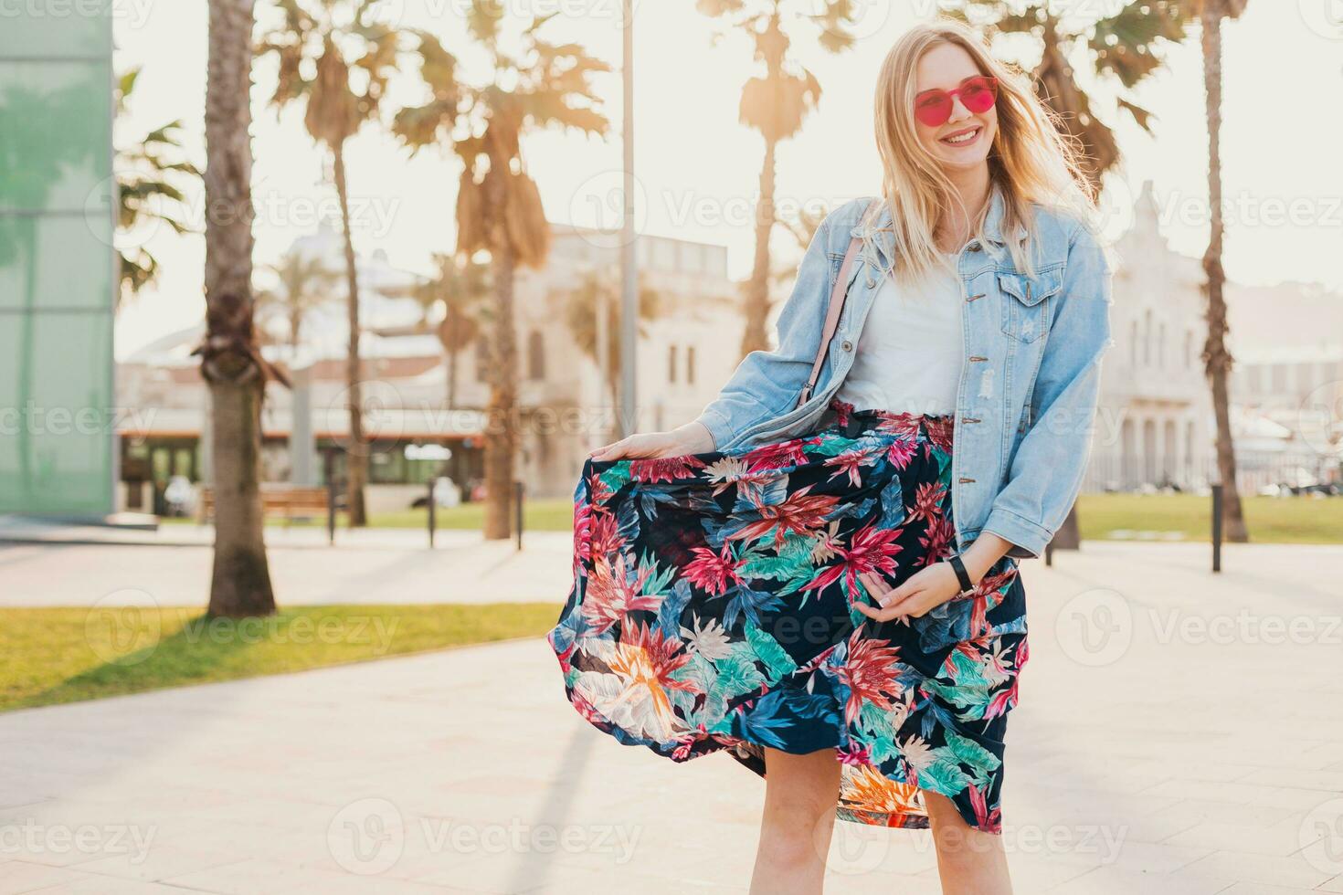 pretty smiling woman walking in city street photo