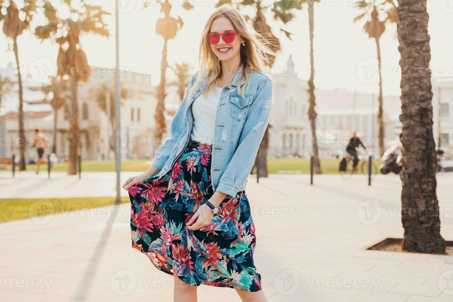 pretty smiling woman walking in city street photo