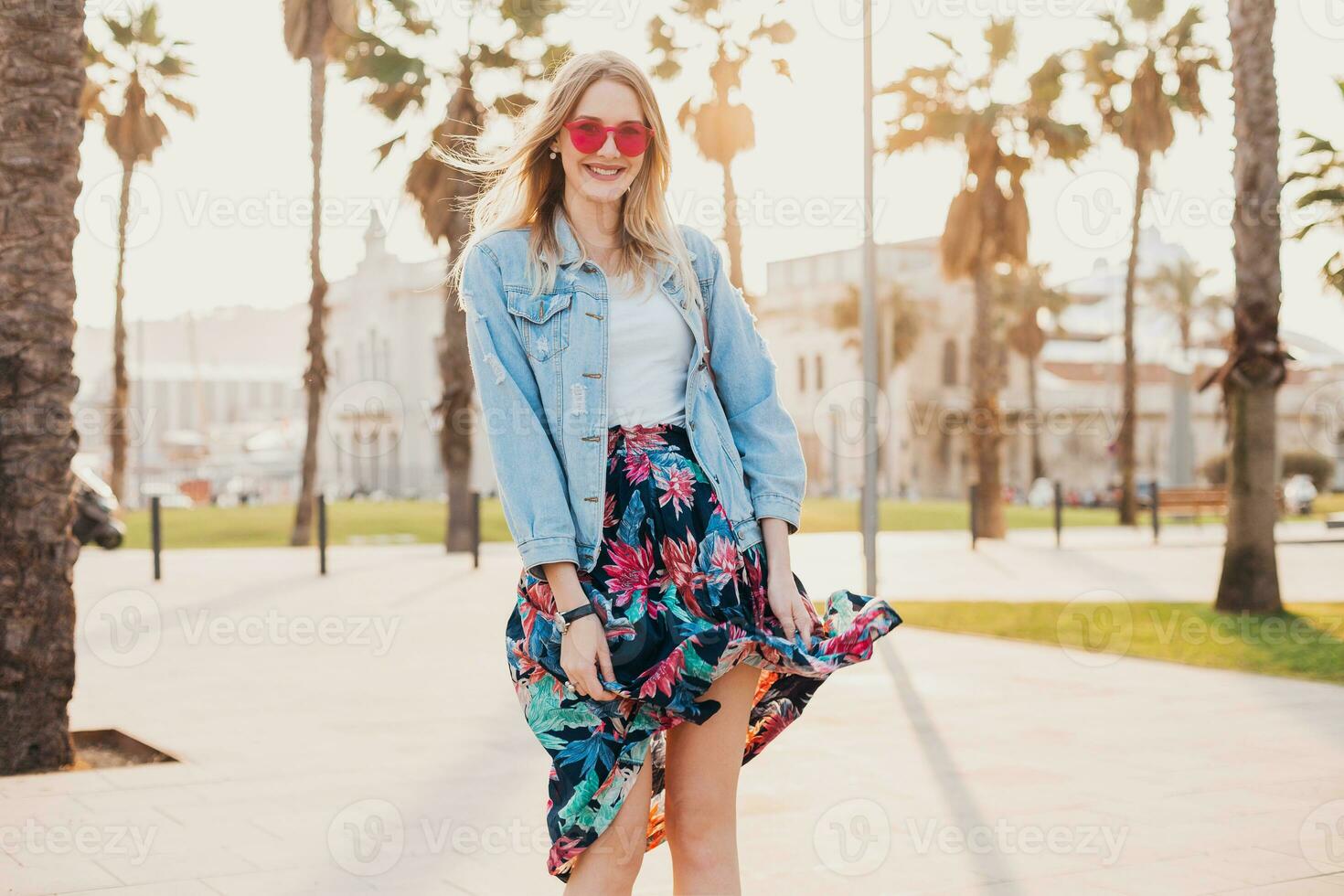 pretty smiling woman walking in city street photo