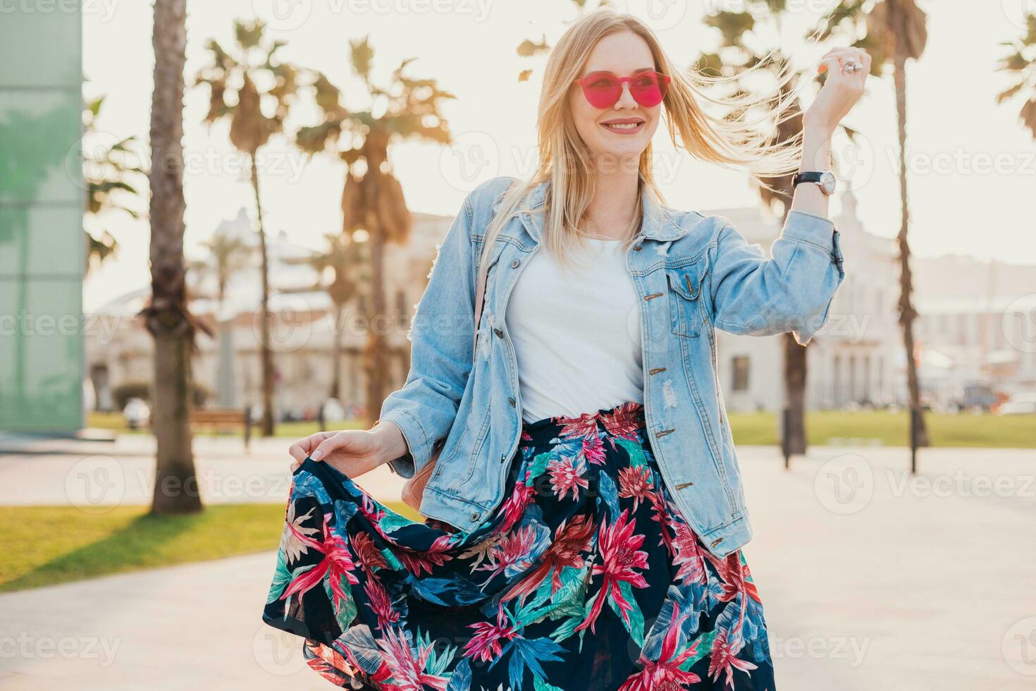 pretty smiling woman walking in city street photo
