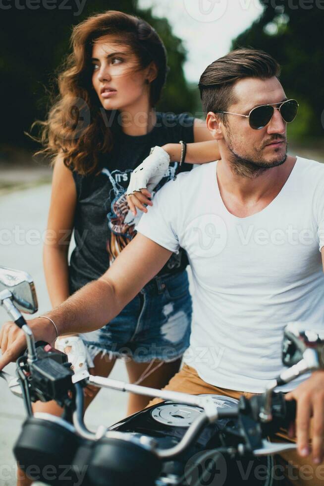 young couple in love, riding a motorcycle, hug, passion, free spirit photo