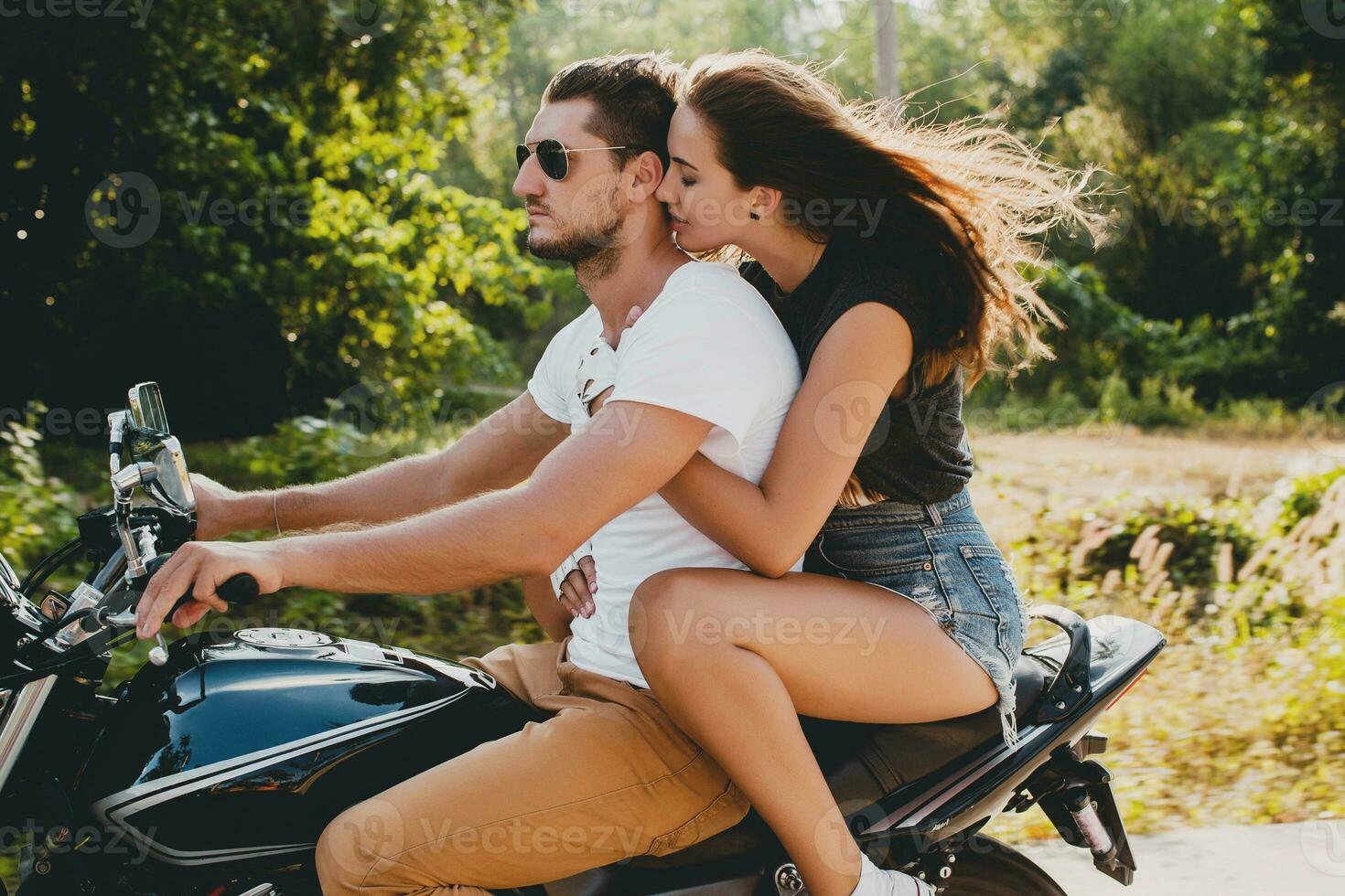 young couple in love, riding a motorcycle, hug, passion, free spirit photo