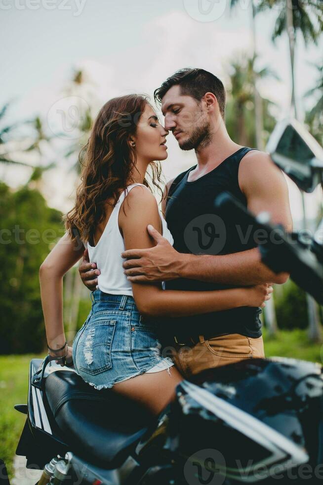 young couple in love, riding a motorcycle, hug, passion, free spirit photo