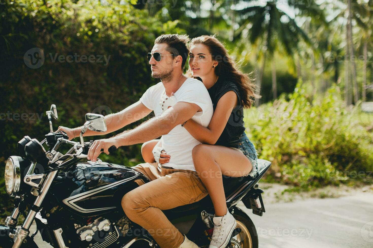 young couple in love, riding a motorcycle, hug, passion, free spirit photo