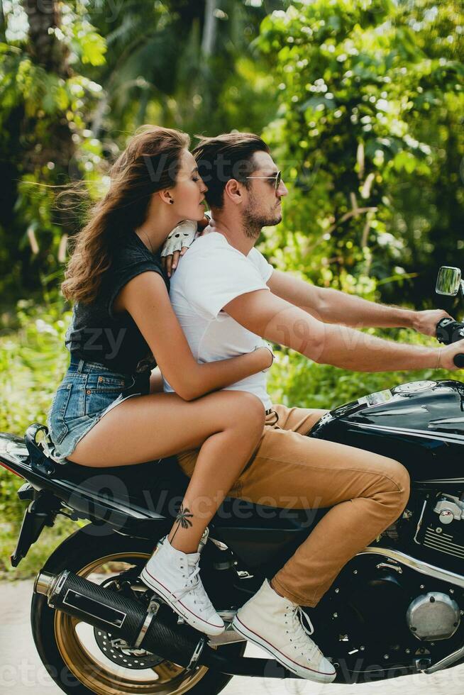 young couple in love, riding a motorcycle, hug, passion, free spirit photo