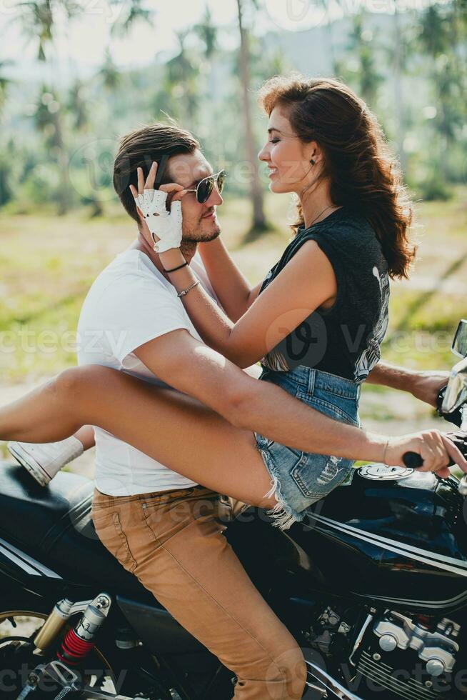 young couple in love, riding a motorcycle, hug, passion, free spirit photo