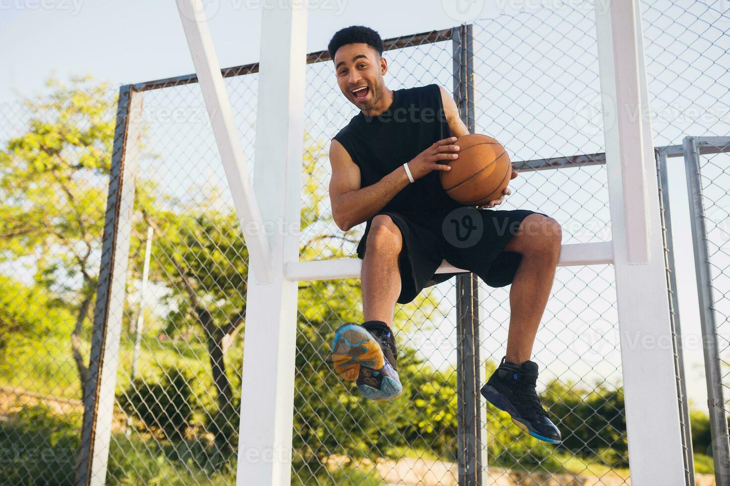 black man doing sports, playing basketball on sunrise, active lifestyle, sunny summer morning photo