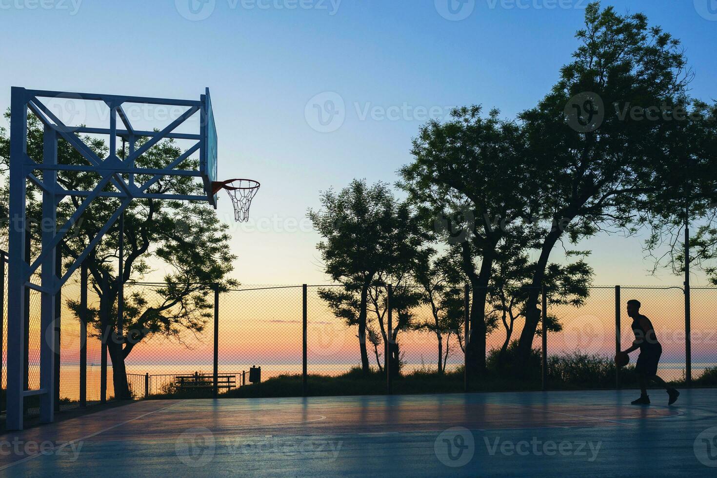 black man doing sports, playing basketball on sunrise, silhouette photo
