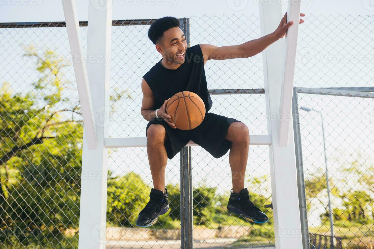 black man doing sports, playing basketball on sunrise, active lifestyle, sunny summer morning photo