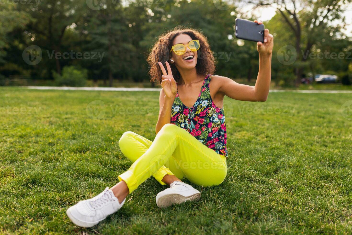 young stylish black woman having fun in park summer fashion style photo