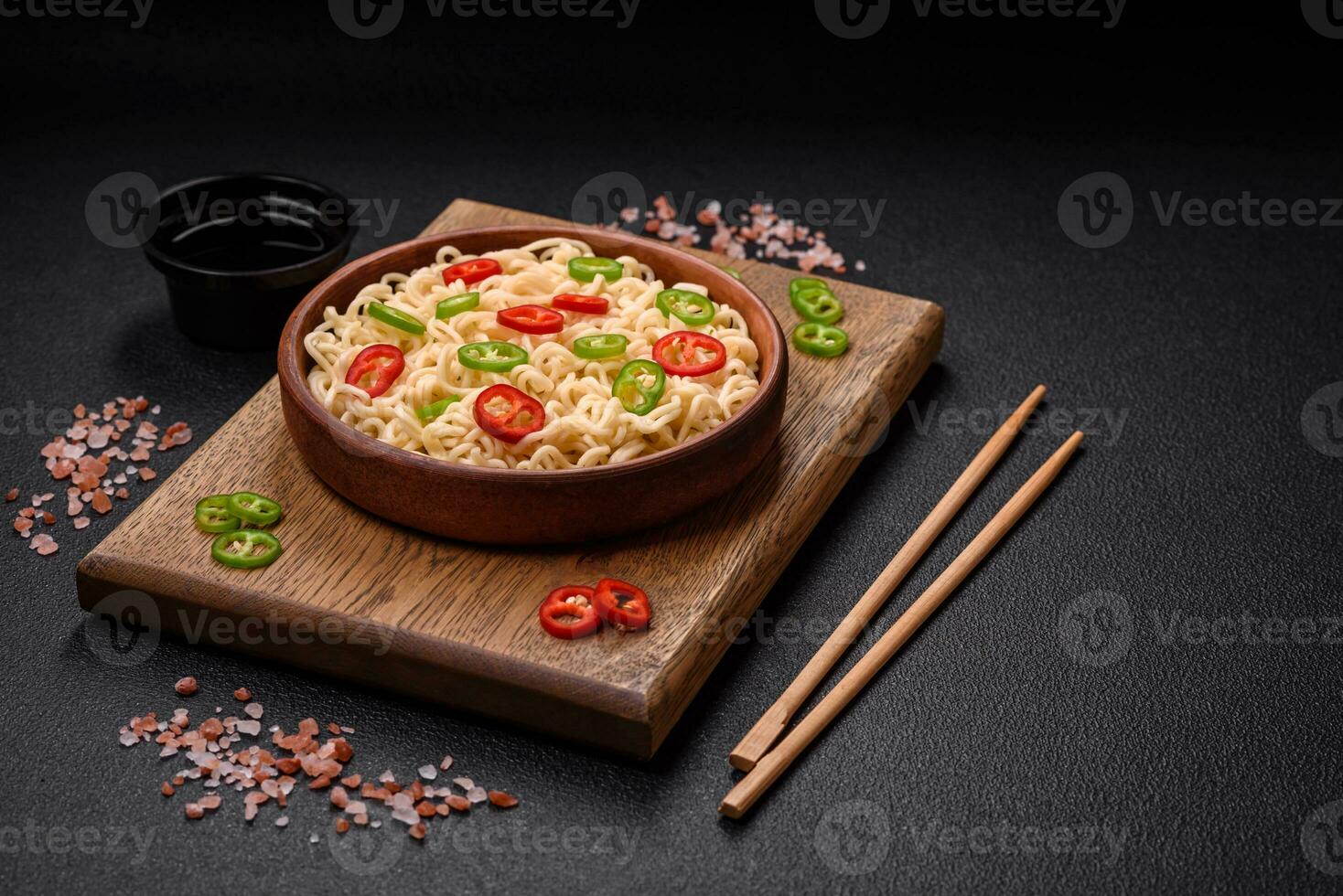 Delicious Asian cuisine dish with rice noodles, peppers, mushrooms and spices photo