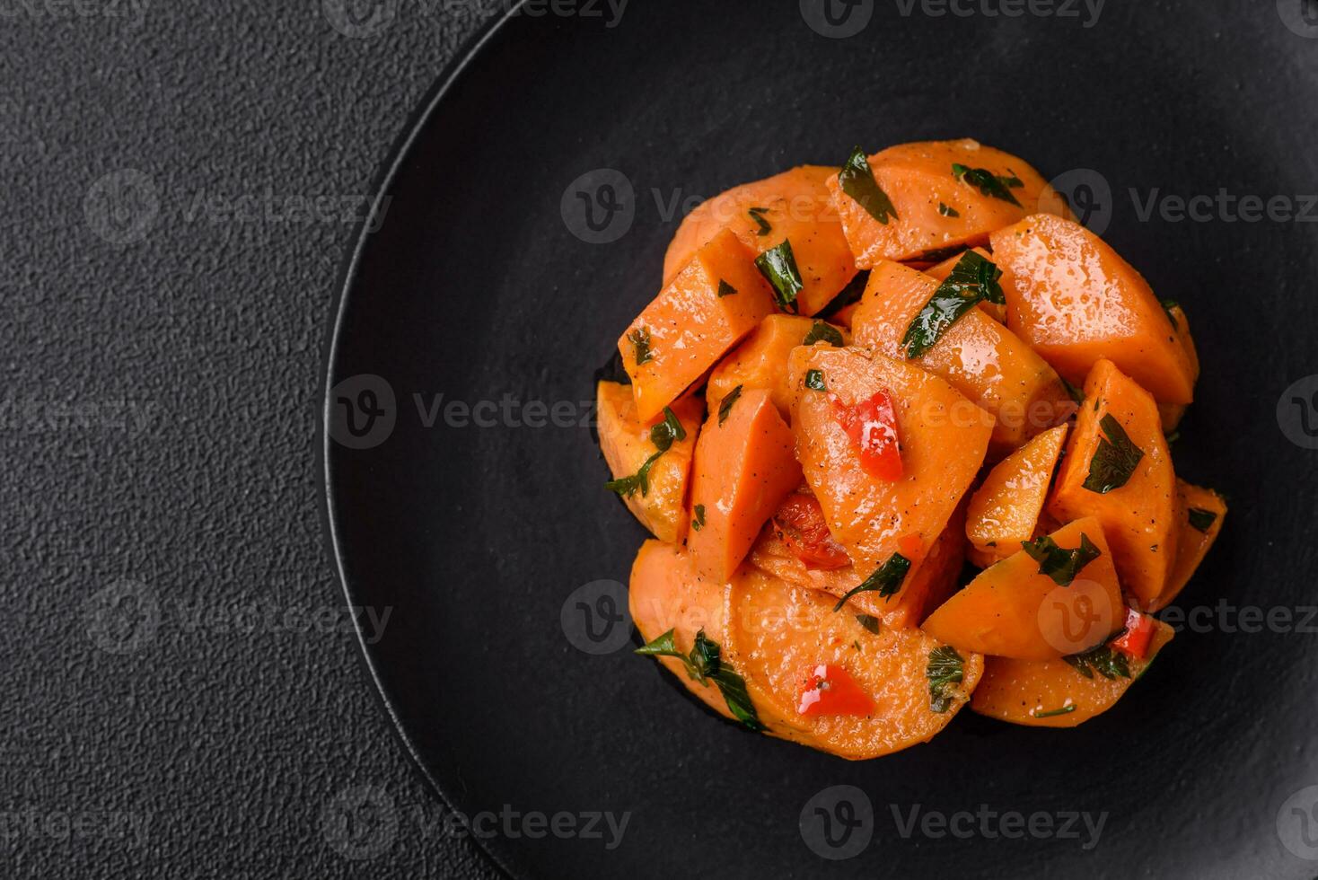 Delicious stewed sweet potato with salt, spices and herbs photo