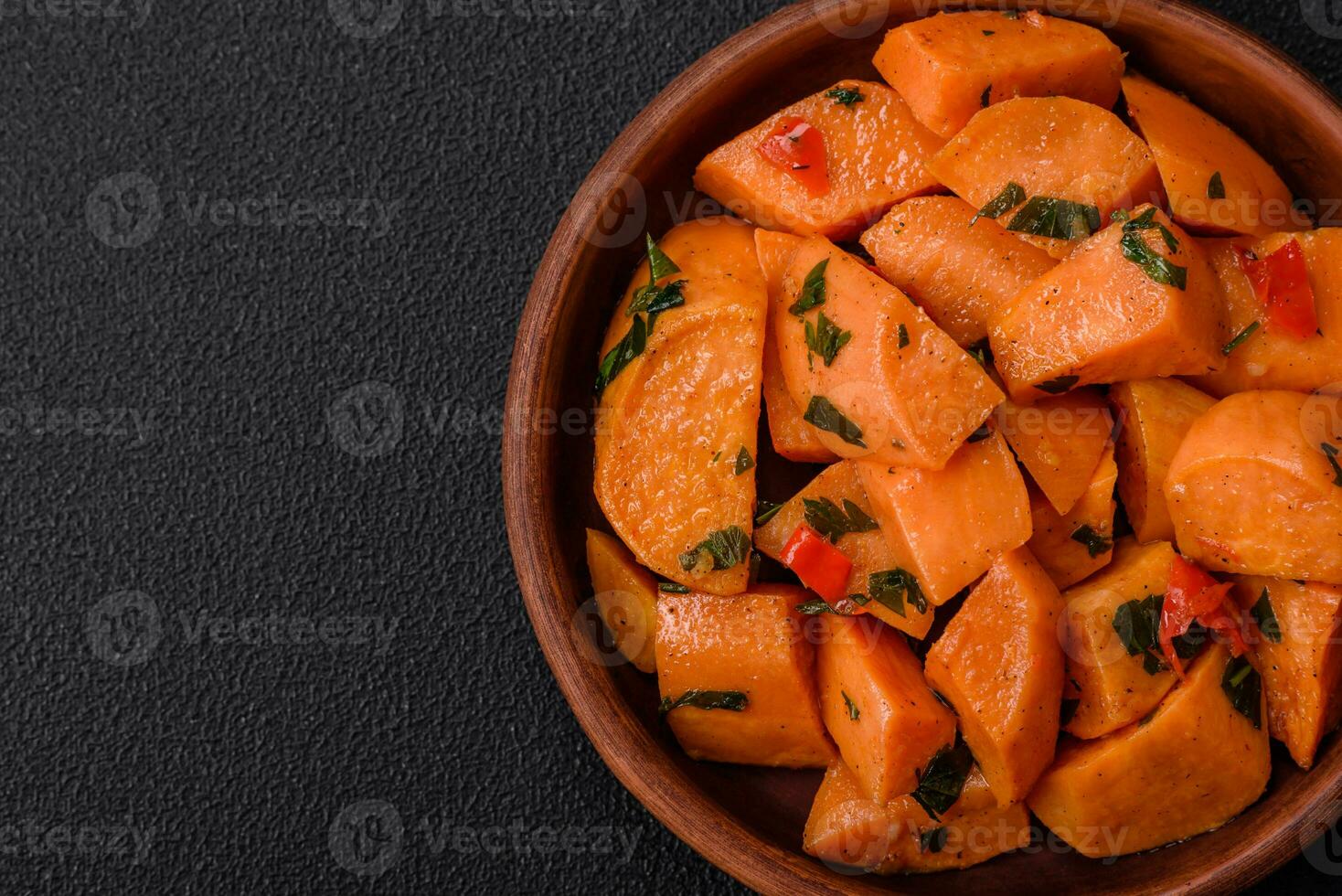 Delicious stewed sweet potato with salt, spices and herbs photo