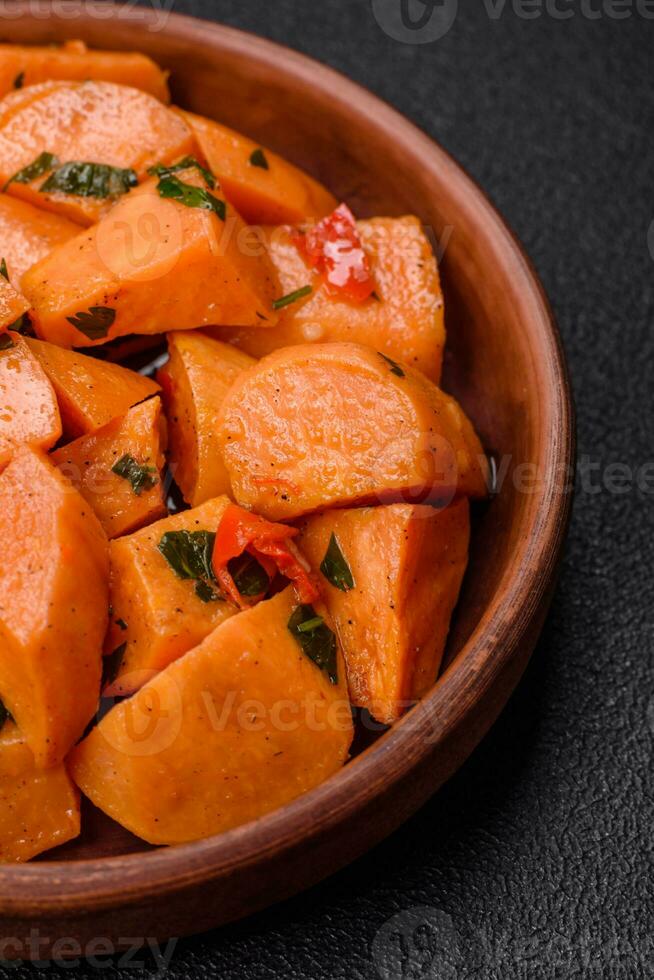 Delicious stewed sweet potato with salt, spices and herbs photo