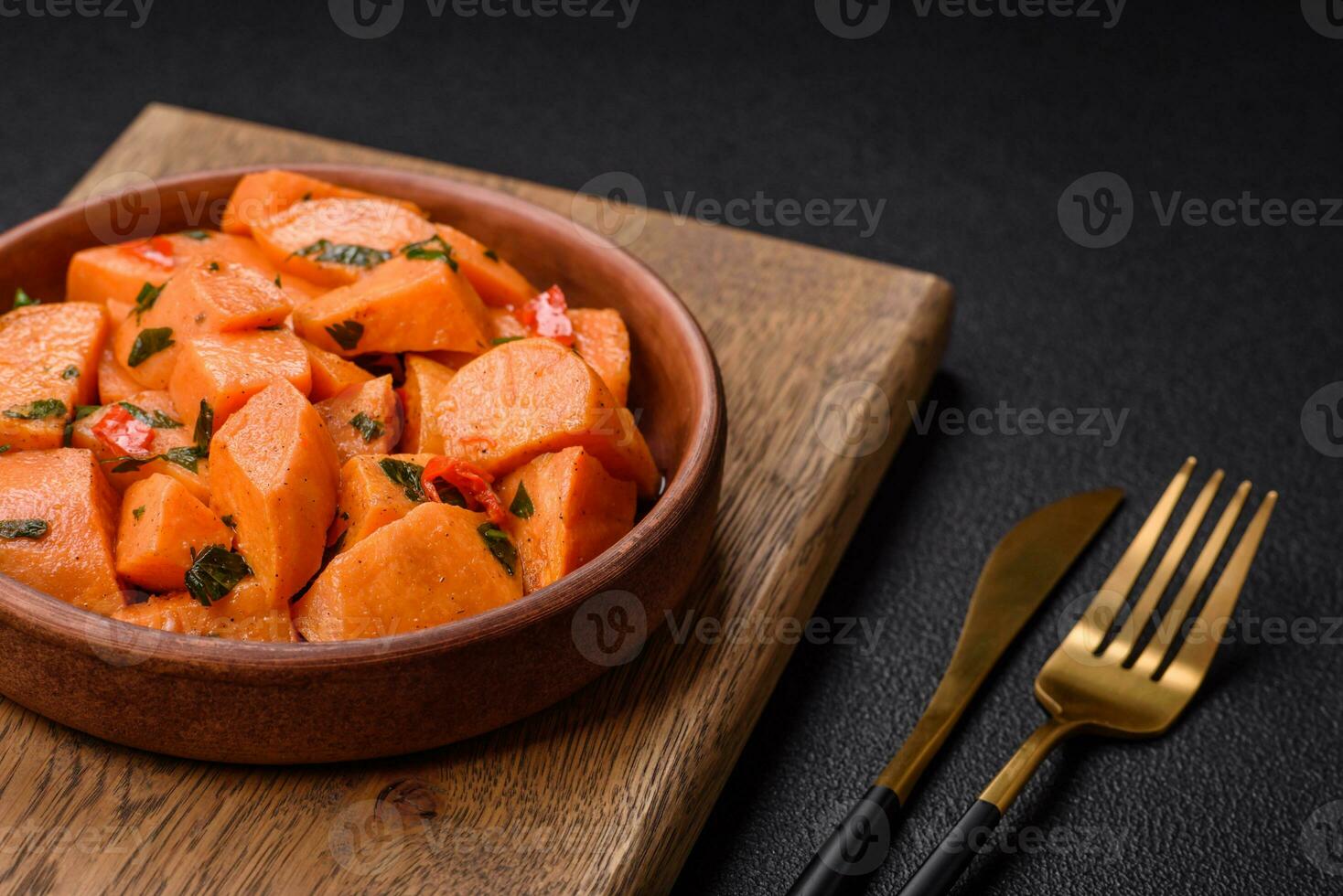 Delicious stewed sweet potato with salt, spices and herbs photo