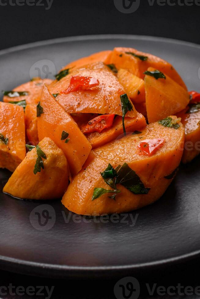 Delicious stewed sweet potato with salt, spices and herbs photo