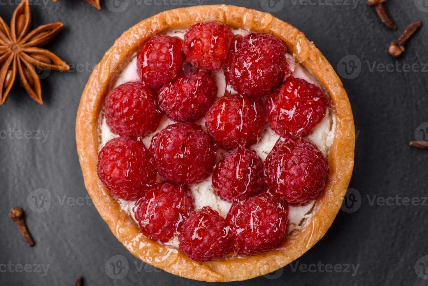 Delicious fresh sweet round tart with ripe raspberries and cream photo