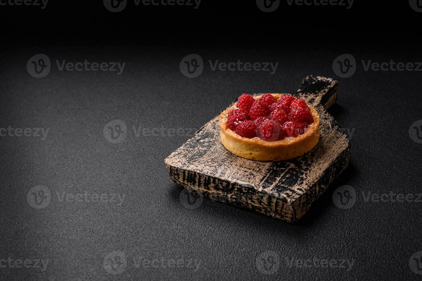 Delicious fresh sweet round tart with ripe raspberries and cream photo
