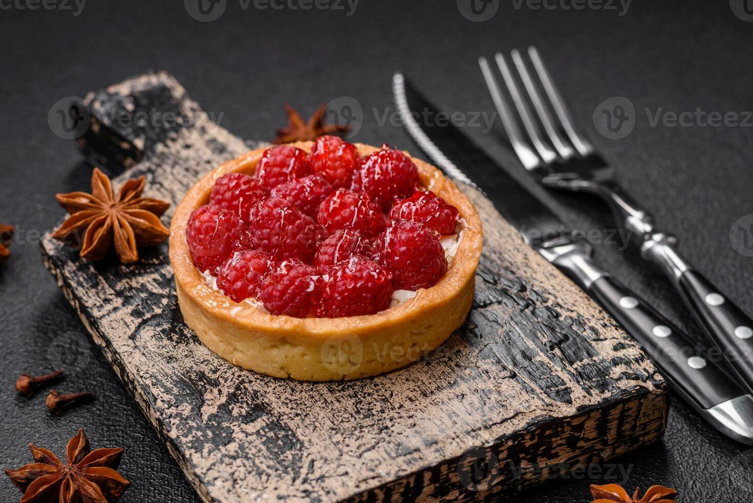 Delicious fresh sweet round tart with ripe raspberries and cream photo