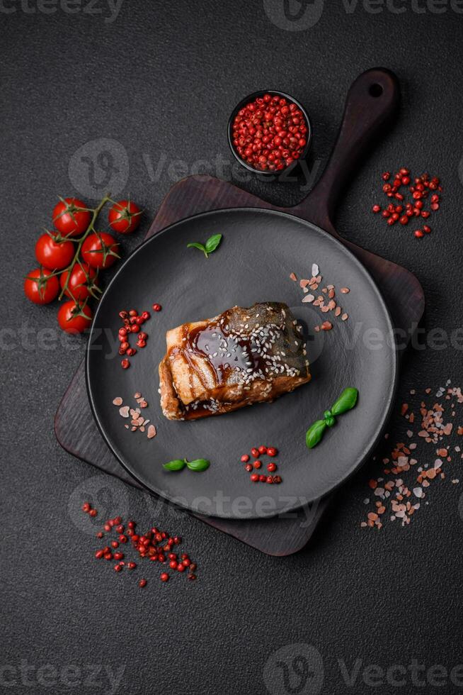 Delicious grilled salmon fillet with salt, spices, herbs and sauce photo