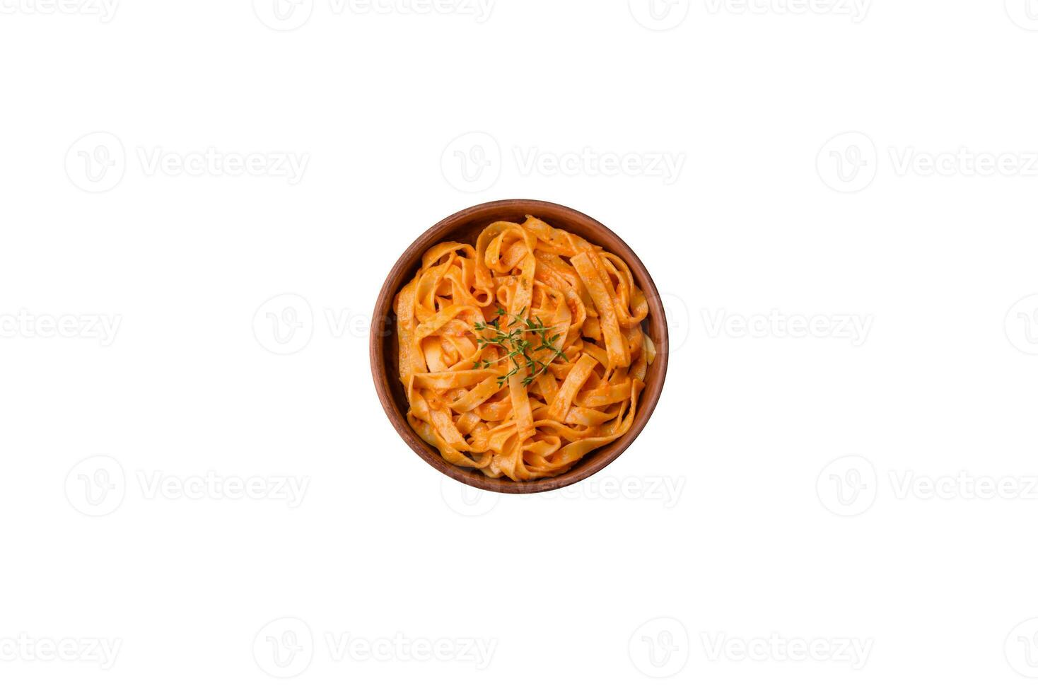 Delicious fresh pasta with pesto sauce, salt, spices and herbs on a ceramic plate photo